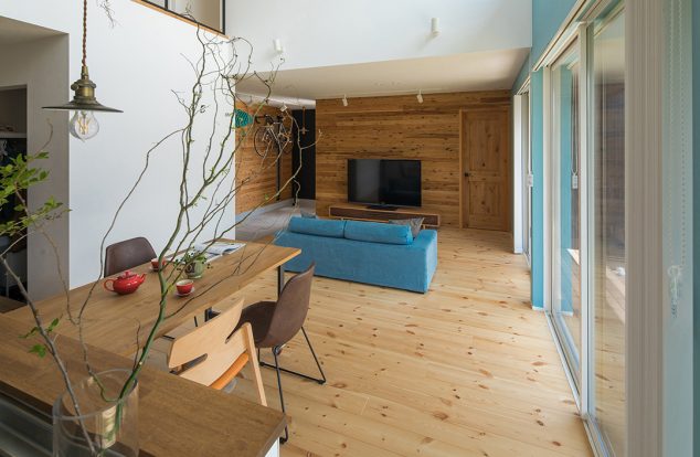 パインの床と白を基調としたデザインで、水色のクロスが印象的なリビング　